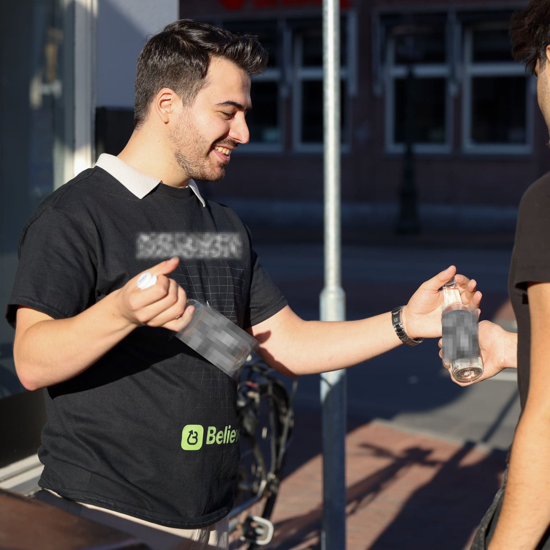 DROP DEX crew member handing a branded bottle to a passer-by on the street